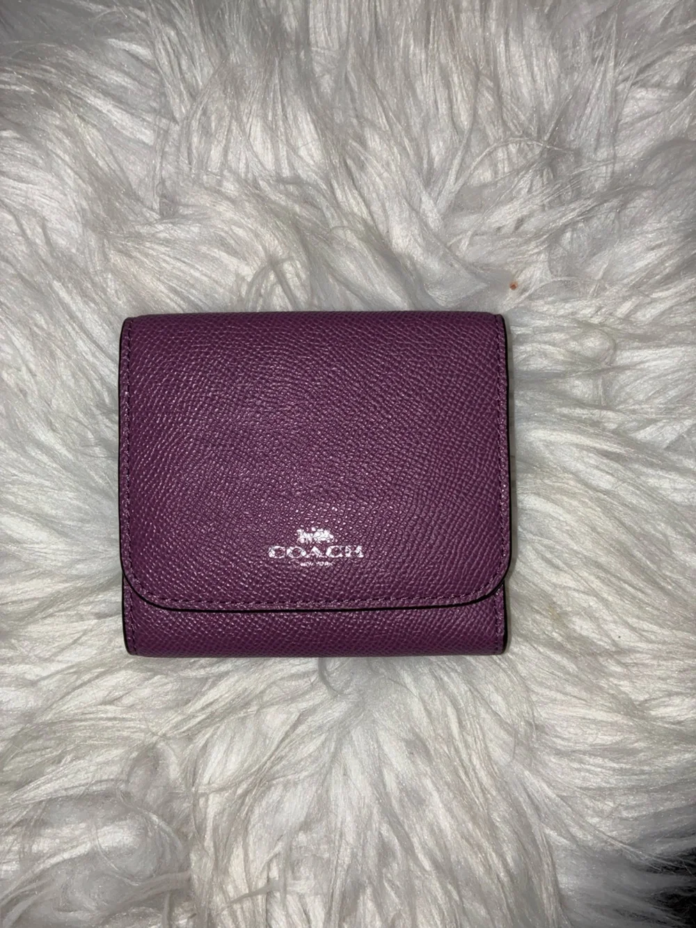 Coach Compact Trifold Pebbled Leather Wallet button closure in Plum/Purple.